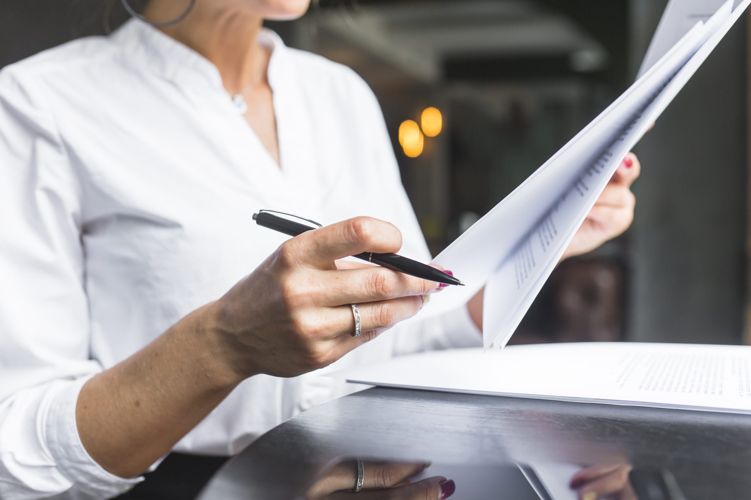 close-up-woman-examining-document